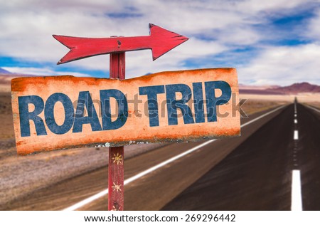 Road Trip sign with road background Royalty-Free Stock Photo #269296442