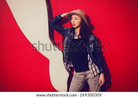 trendy beautiful long haired young model posing on vivid background