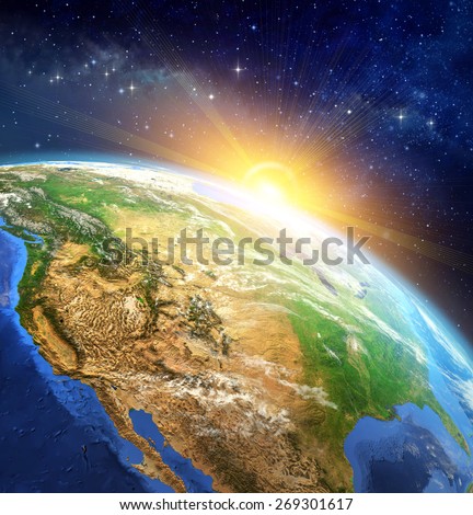Sunrise over the Earth. Very high definition picture of planet earth in outer space with the rising sun. Elements of this image furnished by NASA