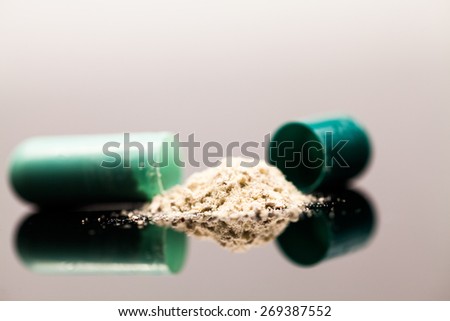 Composition with colorful pills - broken capsules