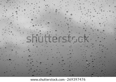 Raindrops on glass window grey