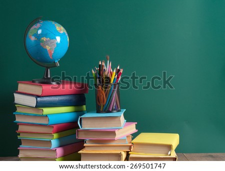 Books on the background of the school board Royalty-Free Stock Photo #269501747