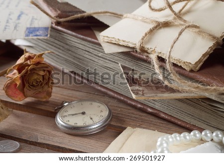 old photos and letters on the wooden table