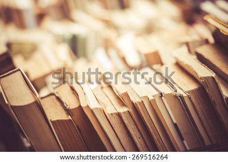 Many old books in a book shop or library. Toned image. Shallow DOF