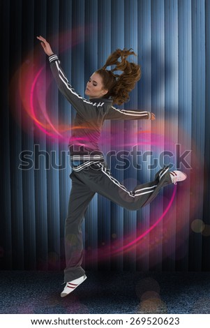 Full length side view of a sporty young blond jumping against dark grey room