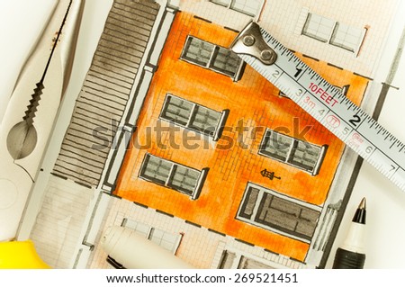 Illustration graphic material with orange shared twin elevation facade fragment with brick wall texture tiling shot with writing tools and measure tape, symbolizing custom approach to building design