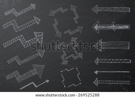 Collection of hand drawn arrows on black chalkboard