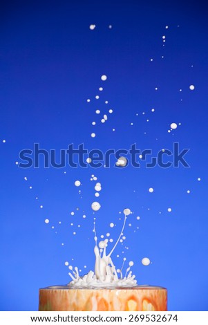 Picture of splash of white liquid on blue background