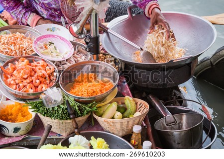 Pad Thai cooking on the boat in Amphawa floating market Royalty-Free Stock Photo #269610203