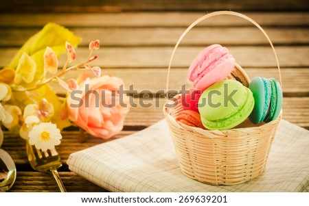 Colourful french macaroons on retro-vintage background soft focus.