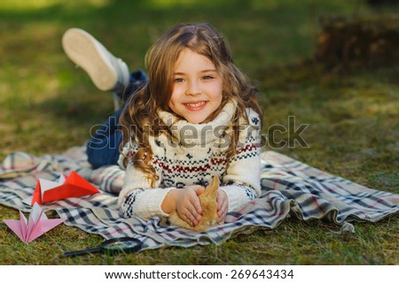 Cute smiling little girl with a rabbit has a easter