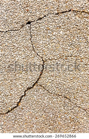 Concrete with small stones, cracks and scratches, weathered, worn. Grungy Concrete Surface. Great background or texture.