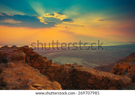 Beautiful sunrise over Masada fortress. Ruins of King Herod's palace in Judaean Desert. Royalty-Free Stock Photo #269707985
