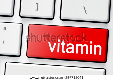 Keyboard with button vitamin. Computer white keyboard with red button vitamin