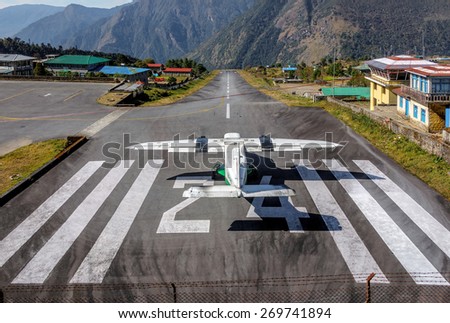 The aircraft on the runway of the Tenzing-Hillary airport Lukla village- Nepal, Himalayas