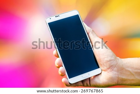 Man hand holding smartphone on apstract blured of background soft focus.