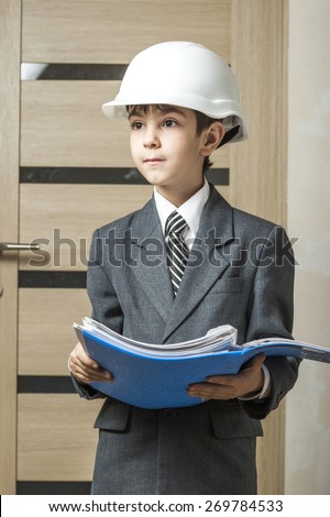 student dressed in imitation engineer construction helmet and took a folder with documents