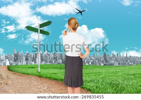 Thinking businesswoman against road leading out to the horizon