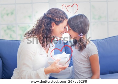 Heart against cute girl offering gift to her mother