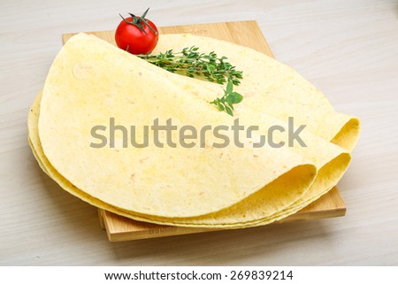 Tortilla stack with herbs on the wood background