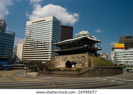 600 year old pagoda style Namdaemun City Gate in central Seoul with modern buildings. Royalty-Free Stock Photo #26988697