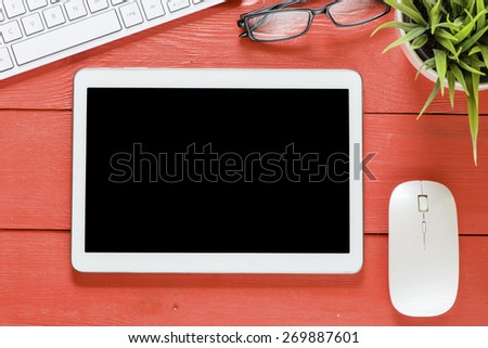 Tablet computer with keyboard.  Tablet computer with keyboard and green plant on wooden background
