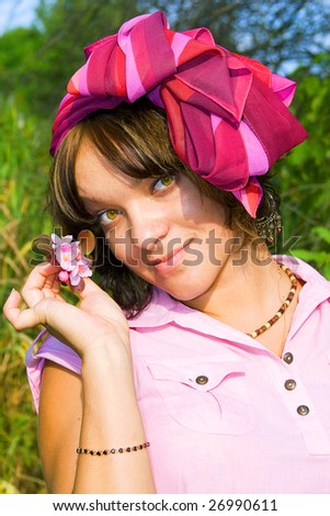 Portrait of young beatiful girl with  blooming cherry flowers. Spring flowering garden