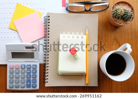 planner and calculator on wooden background with business concept