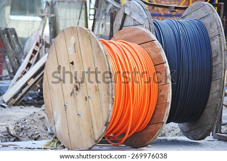 Wooden coil of electric cable on construction site Royalty-Free Stock Photo #269976038