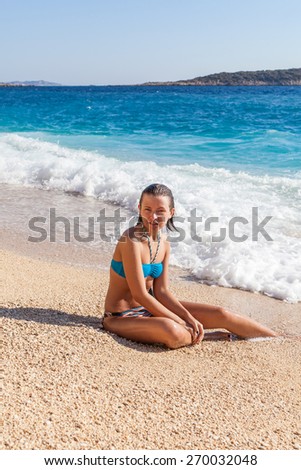 Young woman resting on the beach Kaputash, Turkey 