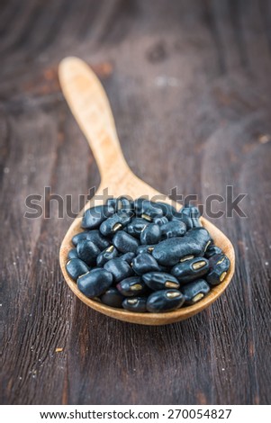 Black beans on wooden background - vintage effect style pictures