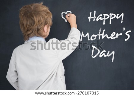 Cute pupil writing on board against black background