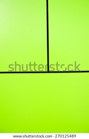 Green wall tiles affixed to  a vertical wall of the building
