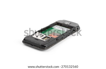 Back of an old broken cell phone over a white background.
