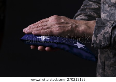 USA flag holding by soldier close up