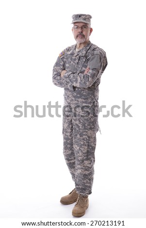 Military man standing with folding arms, studio on white background
