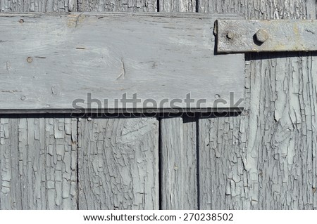 Old wall of wooden planks with paint cracked .
