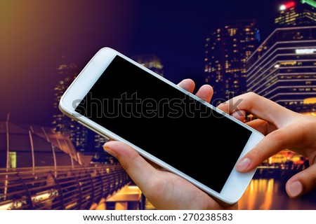 woman hand hold and touch screen smart phone, tablet,cellphone on blurred beautiful blue sky with palm tree on the beach background.