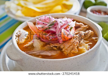 Encebollado, fish stew, served with banan chips and lemon. Typical ecuadorian dish, Ecuador. Royalty-Free Stock Photo #270241418