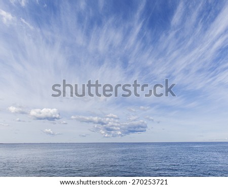 Seascape. Clear blue sky  and white clouds