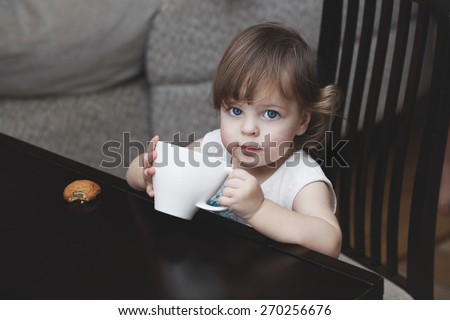 The girl child with a mug of home
