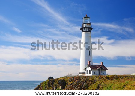 white pigeon point lighthouse with a blue sky in a sunny day