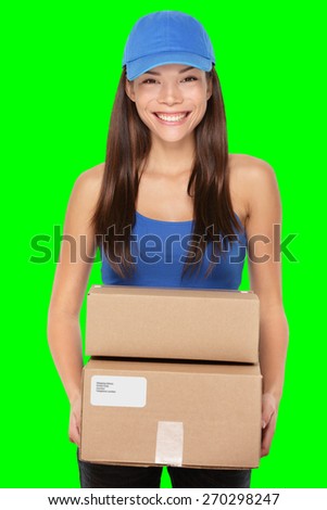 Delivery person holding packages wearing blue cap. Woman courier smiling happy isolated on green screen chroma key background.. Beautiful young mixed race Caucasian / Chinese Asian female professional