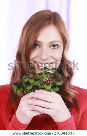 Happy woman holding lucky clover