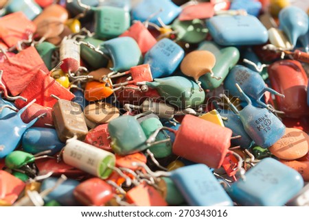 Background pile of old capacitors with led bulbs, which use colorful.