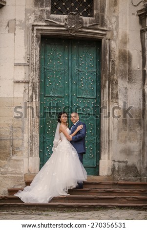 Wedding couple walking in Lviv architecture