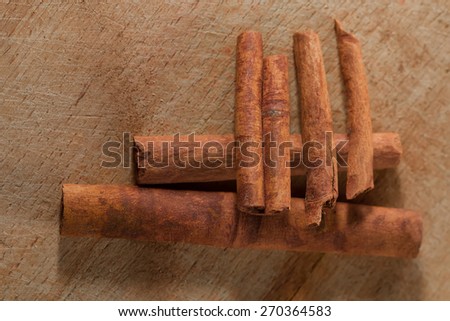 whole cinnamon sticks on wooden background