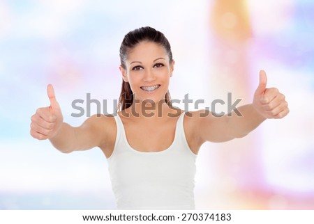 Cute teenager girl with brackets saying ok on a unfocused background