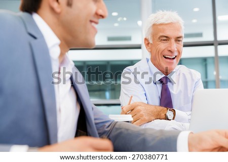 Two businessmen discussing their business in office