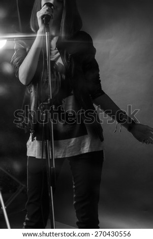girl singing into a microphone in a studio